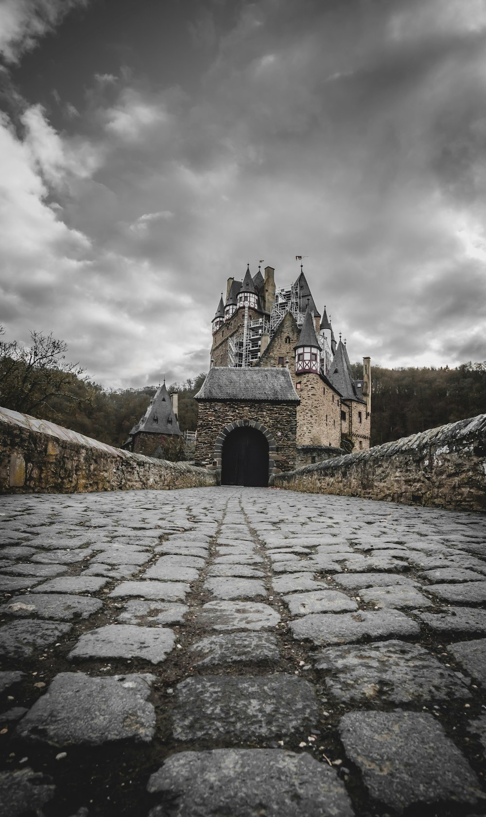 an old castle with a stone walkway leading to it