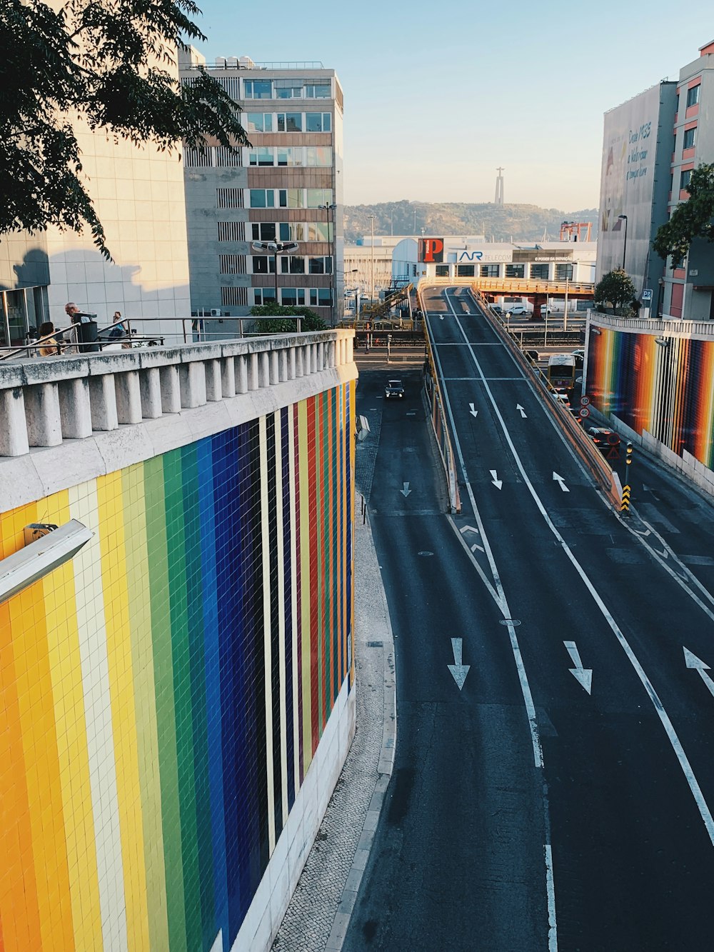 a city street with a rainbow painted wall