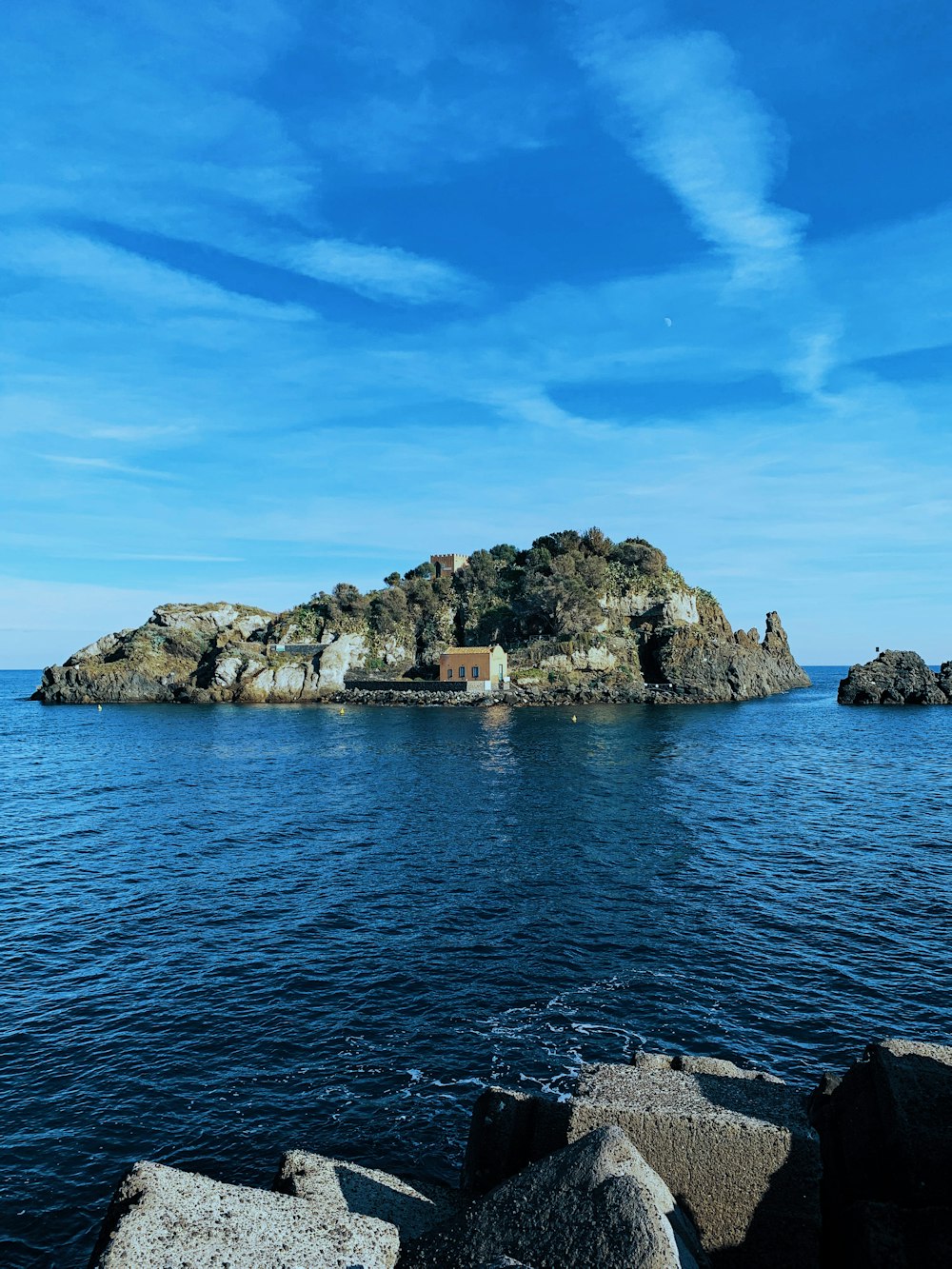 brown and gray rock formation on blue sea under blue sky during daytime