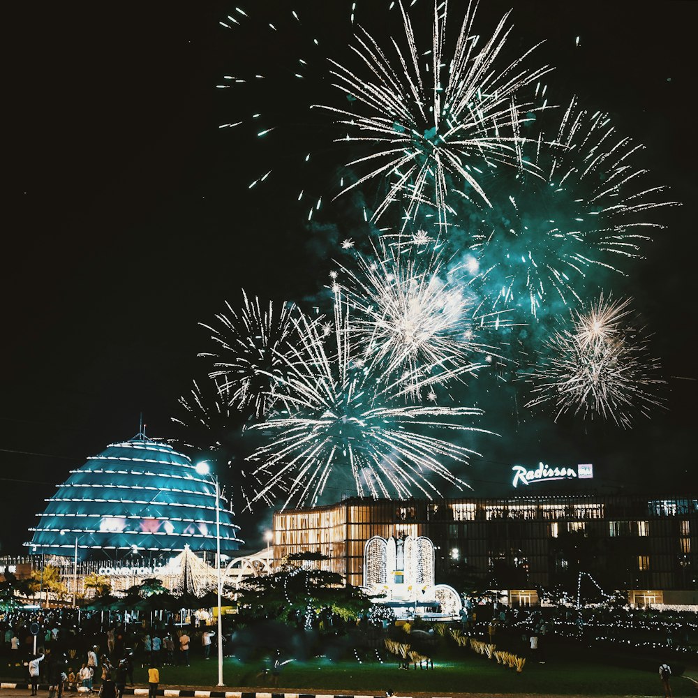 fireworks display over city buildings during night time