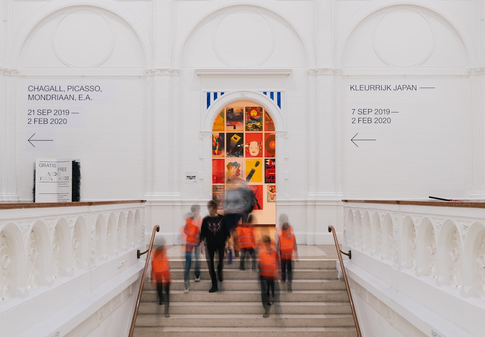 a group of people walking up a flight of stairs