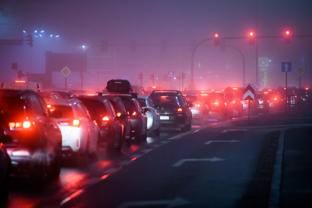 a foggy city street filled with lots of traffic