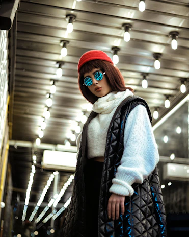 Urban streetwear model posing confidently under vibrant concert lights