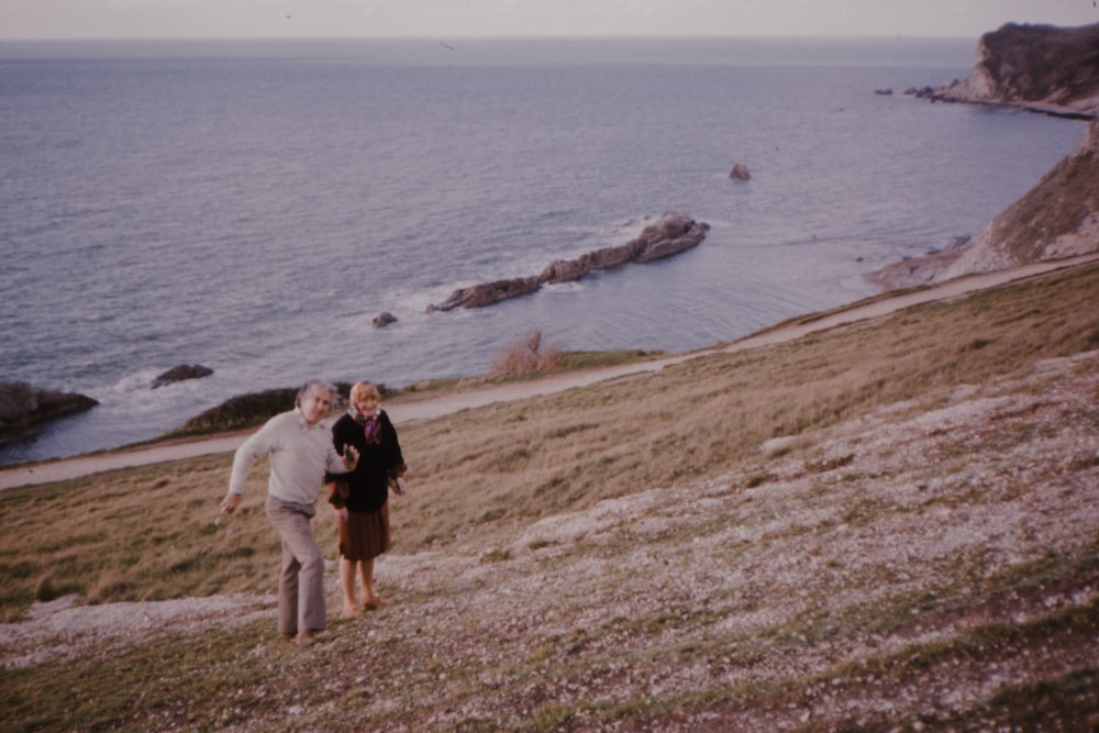 a couple of people that are standing in the grass