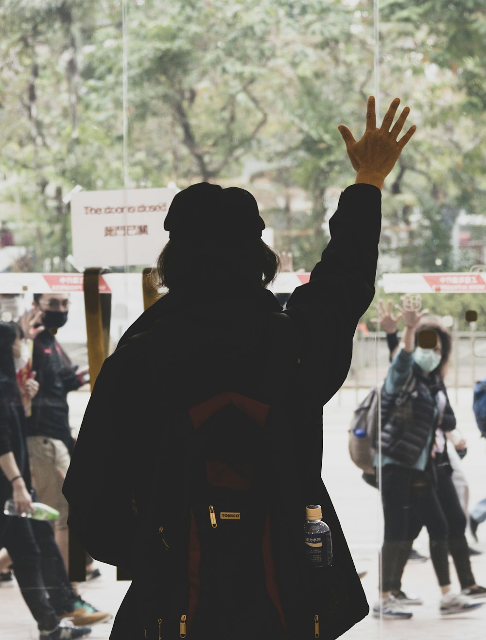 man in black hoodie raising his hands