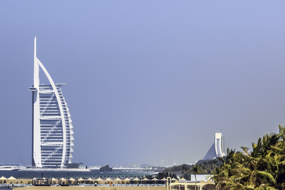 a tall white building sitting on top of a beach