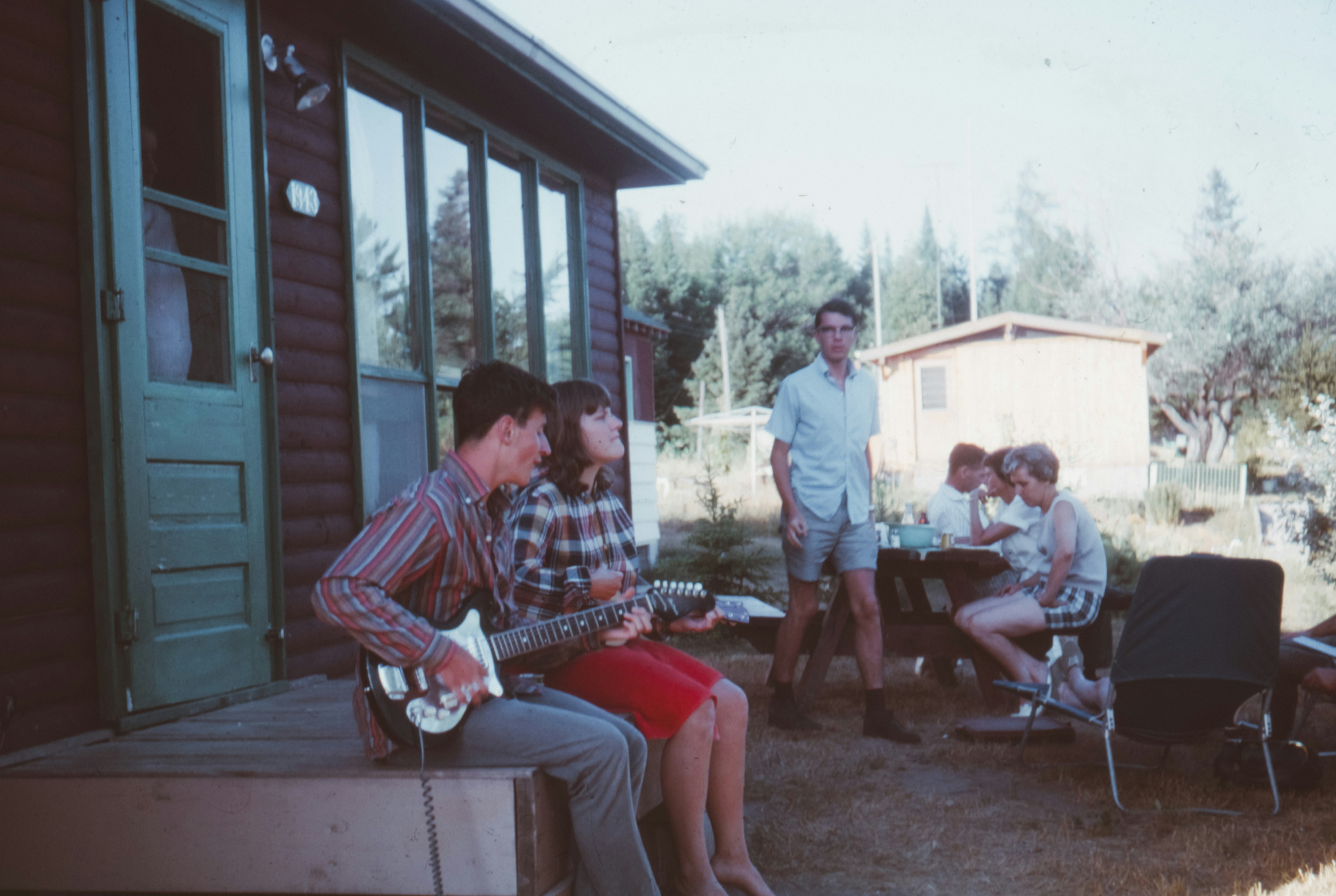 family enjoying the porch of a park model cabin - park model trailer brands