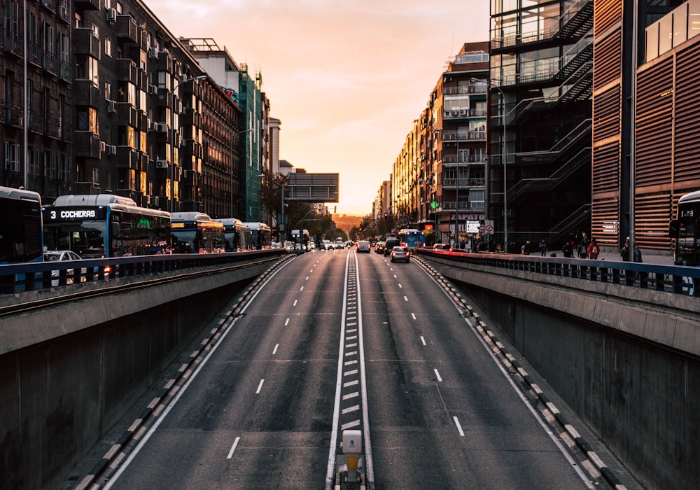 cars on road between buildings during daytime