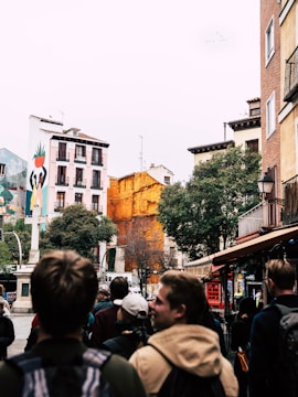 A vibrant street scene in Tlalpan showing residents engaged in a public forum