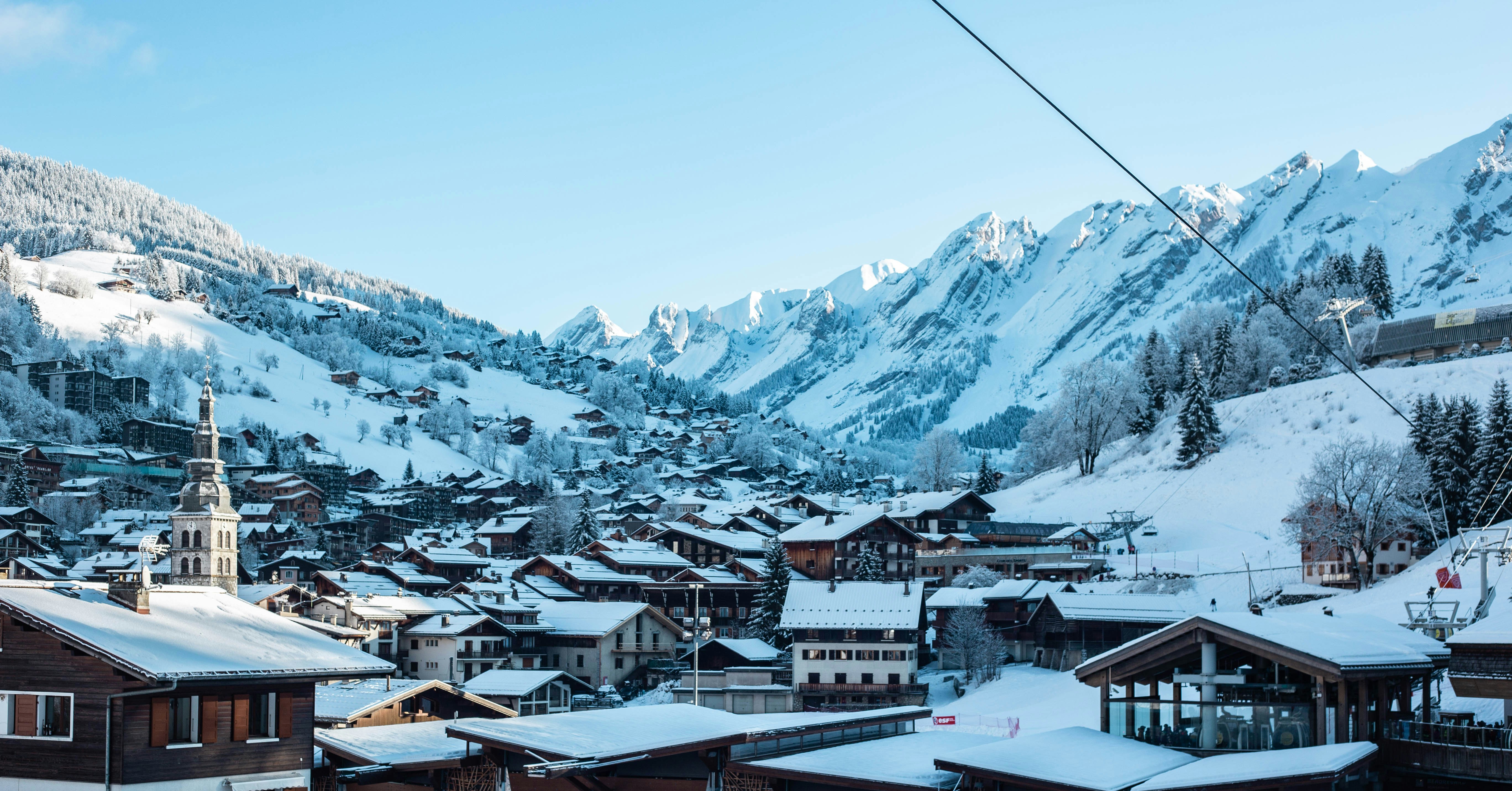 a ski resort with a mountain in the background, White city