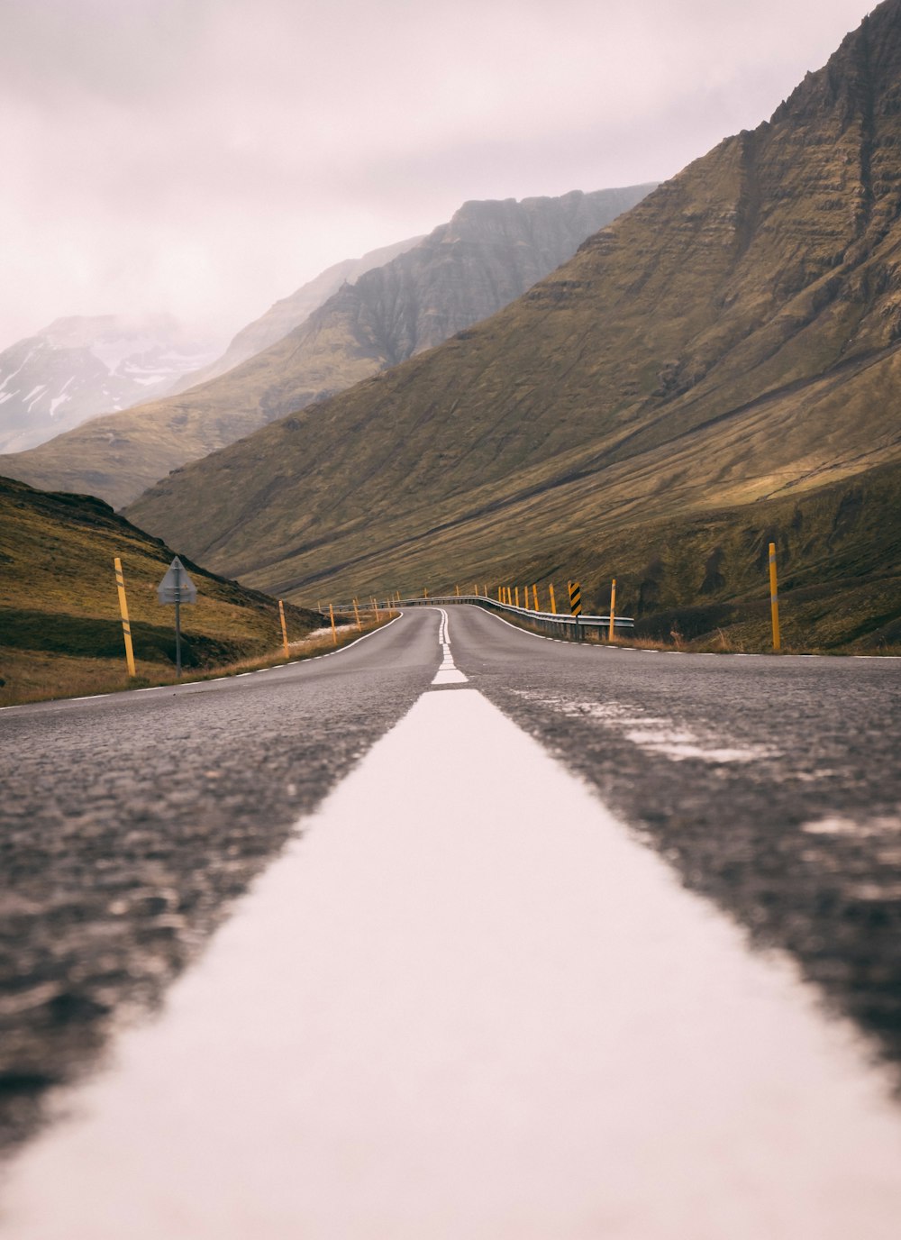 gray asphalt road between brown mountains during daytime