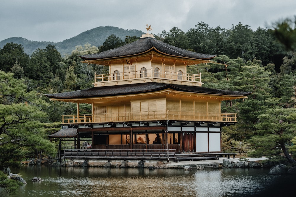 brown and white wooden house near body of water during daytime