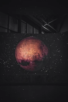 High-resolution image of Mars with atmospheric glow and surface textures visible against deep space.