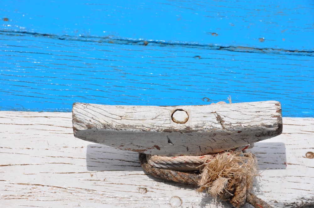 brown rope on white wooden plank