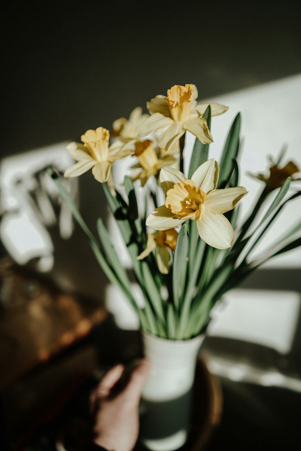 a vase filled with yellow flowers on top of a table