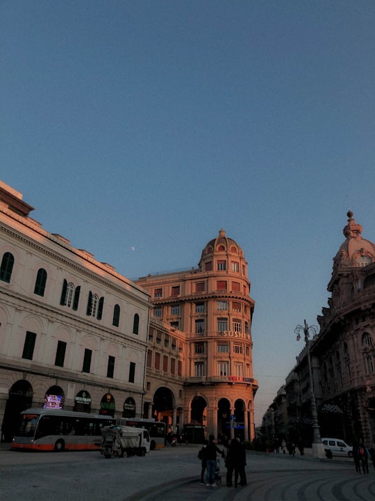 white and brown concrete building in Piazza De Ferrari Italy