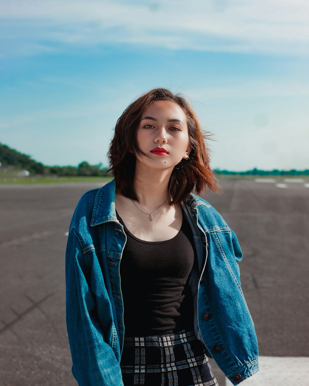 Woman in black tank top and blue denim jacket standing on gray concrete  pavement during daytime photo – Free Misamis occidental Image on Unsplash