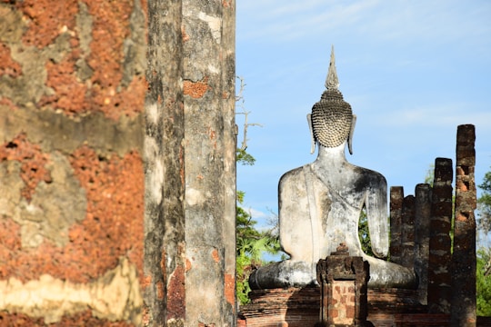 Close-up of the smooth, weathered granite Buddha statues at Gal Vihara under a clear blue sky.
