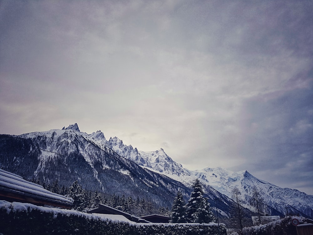 snow covered mountain under cloudy sky during daytime