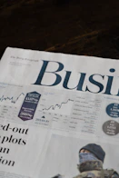 A business section of a newspaper with stock market charts and financial data