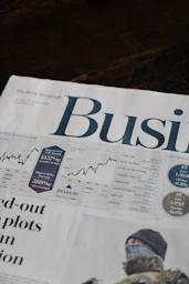 A business section of a newspaper with stock market charts and financial data