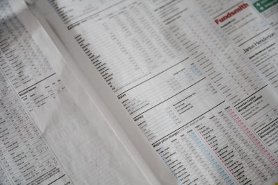 A newspaper page focused on financial information, including stock market data, recent issues, rates, major price changes, and investment fund details. Columns of numbers are interspersed with headings and small charts, printed on plain paper with a slightly off-white background.