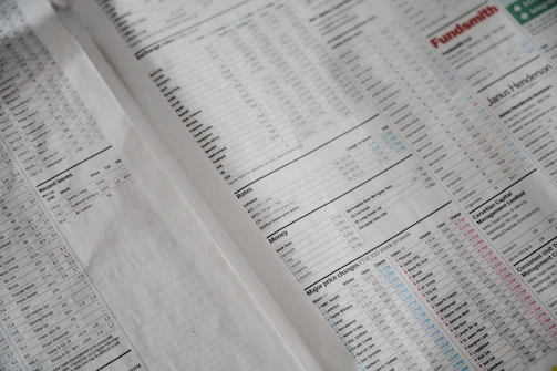 A newspaper page focused on financial information, including stock market data, recent issues, rates, major price changes, and investment fund details. Columns of numbers are interspersed with headings and small charts, printed on plain paper with a slightly off-white background.