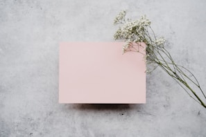a pink paper with a bunch of flowers on top of it