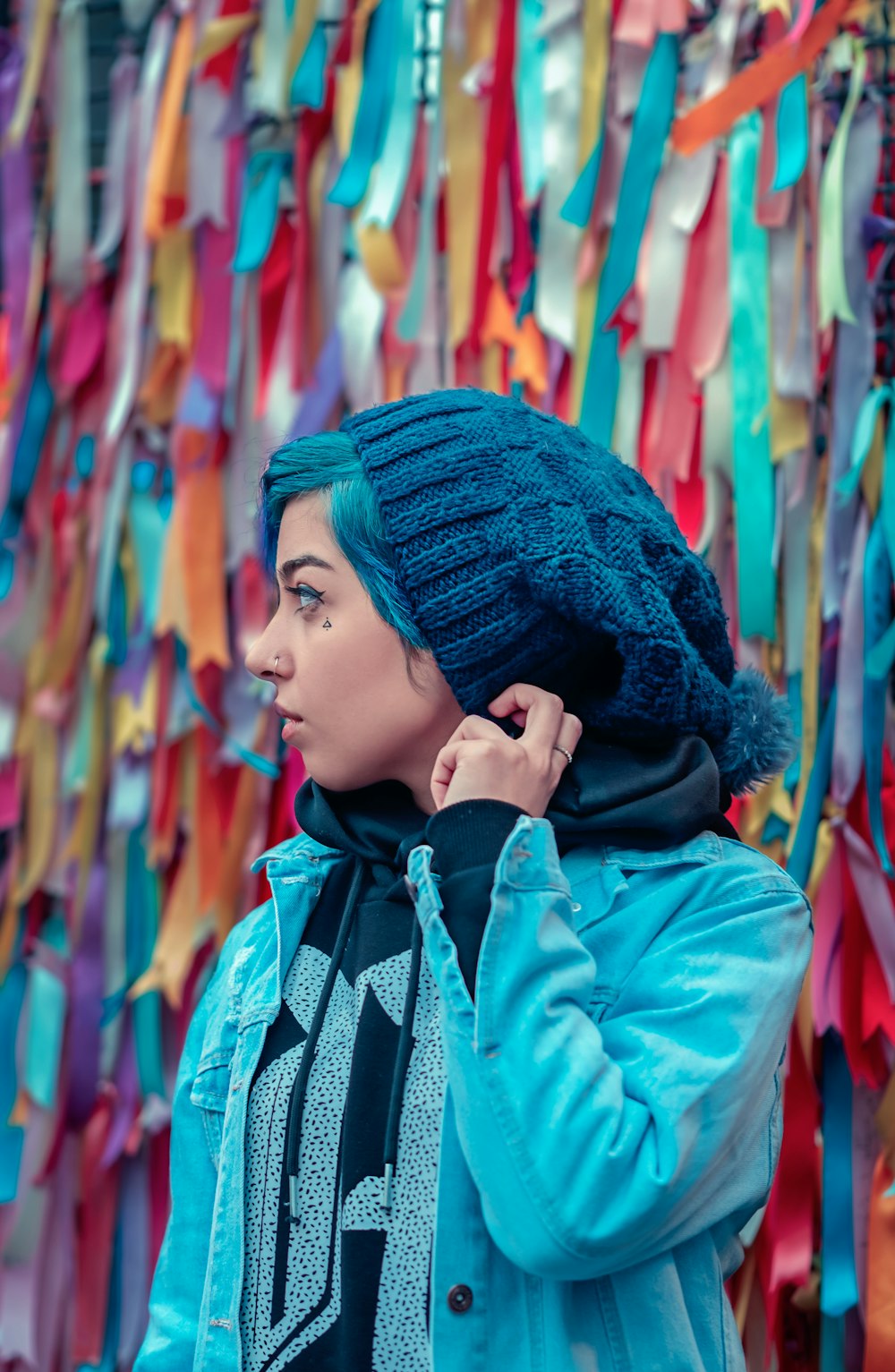 woman in blue knit cap and blue and white scarf