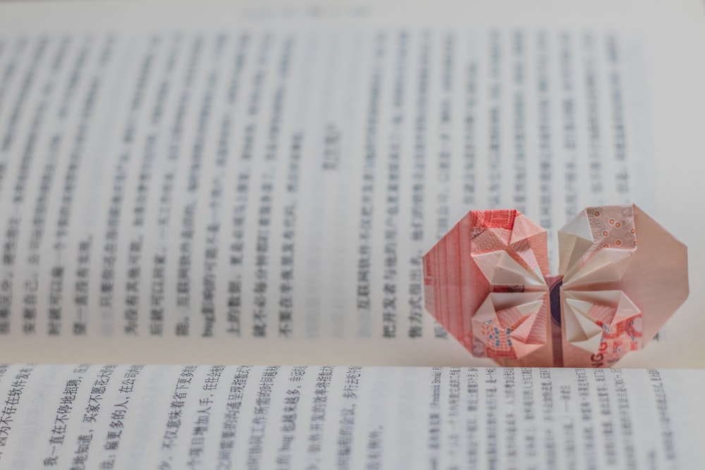 red and white paper boat on white printer paper