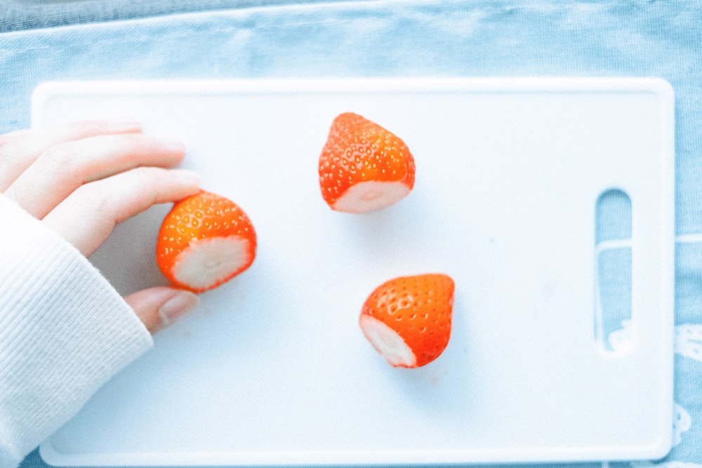 person holding white and orange ice cream