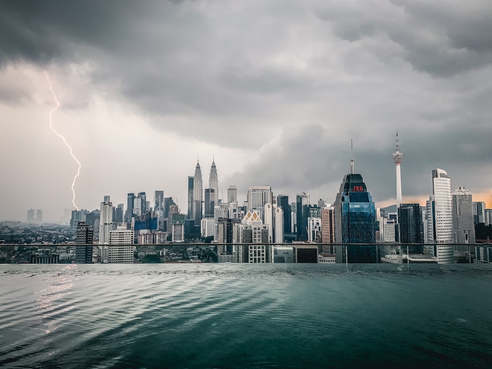 a view of a city with a lightning bolt in the sky