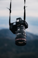 black nikon dslr camera on black tripod