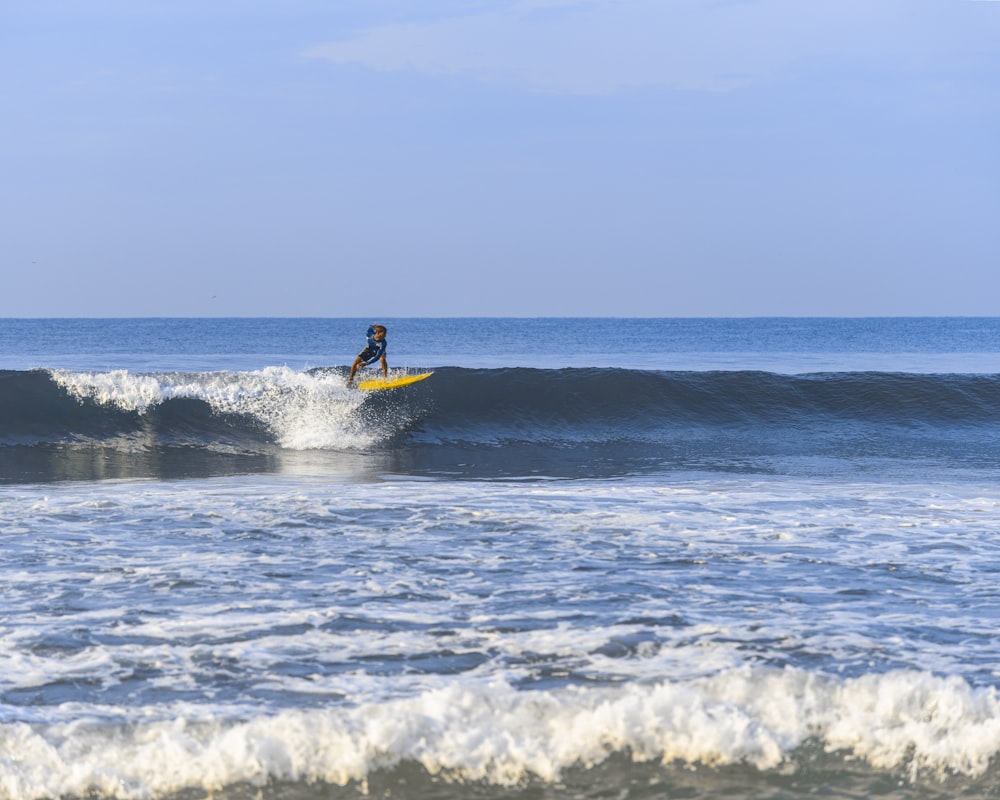 person surfing on sea waves during daytime