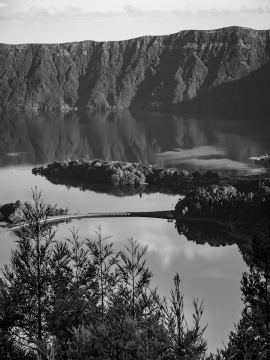 grayscale photo of lake and mountain in Sete Cidades Portugal