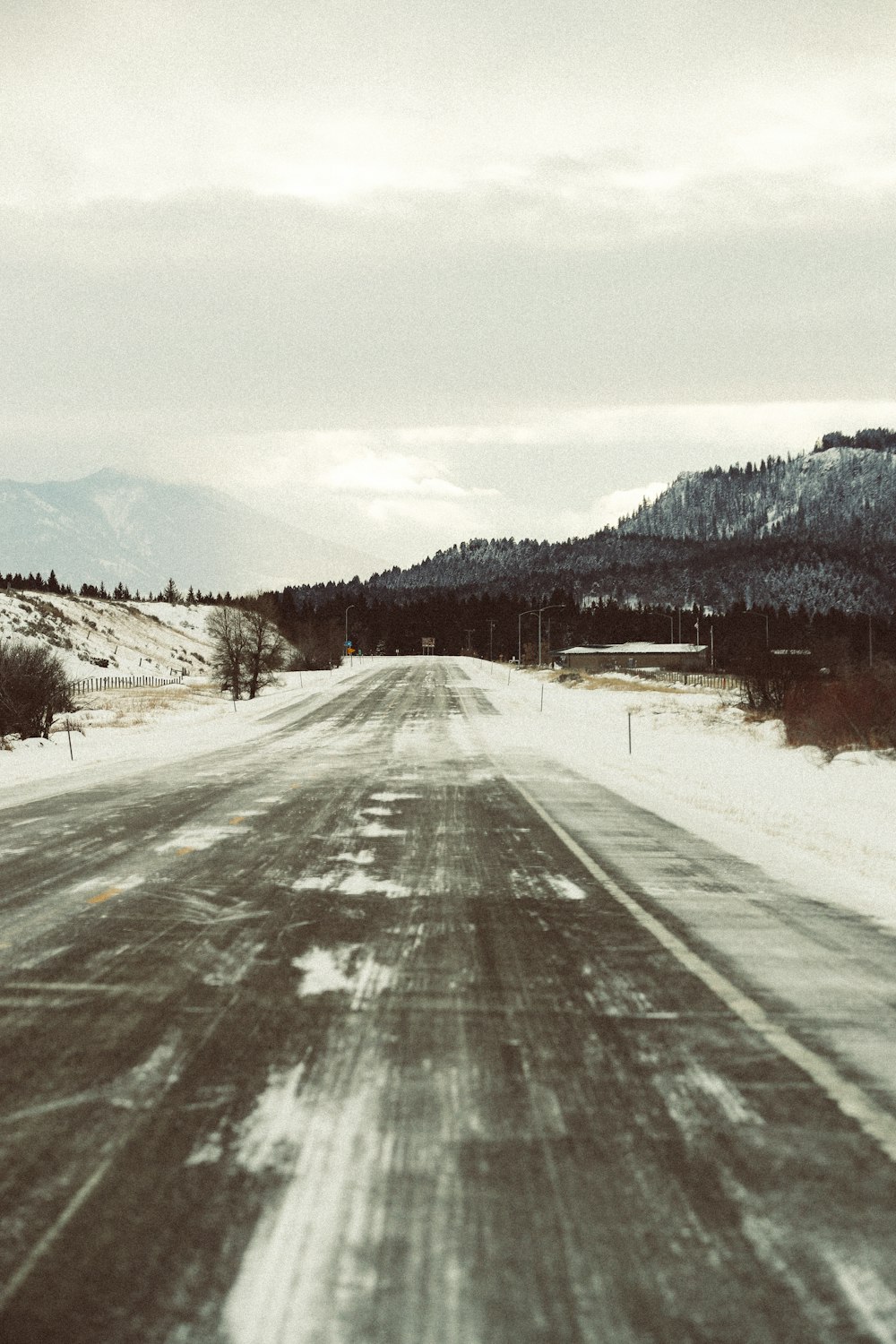 snow covered road during daytime