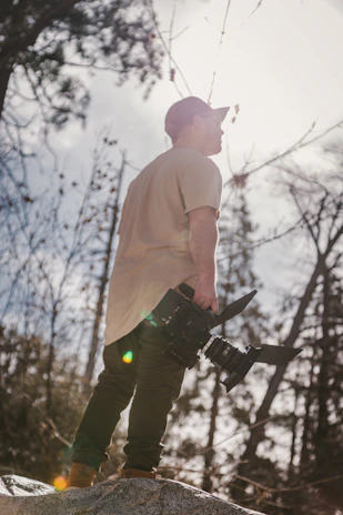 A vibrant snapshot capturing a team member adjusting camera equipment in a sunlit outdoor setting.