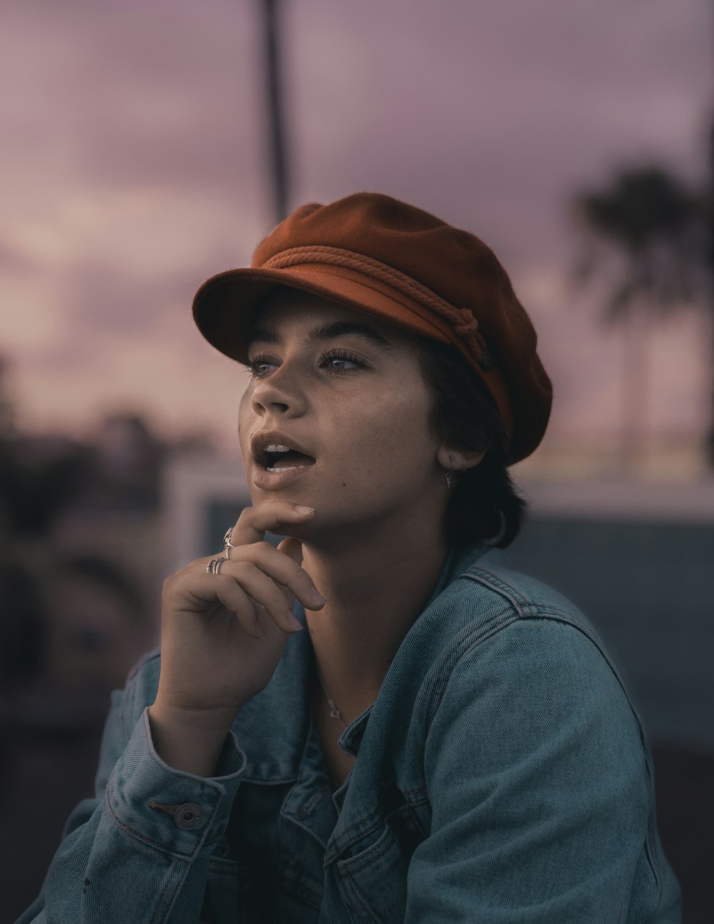 woman in gray shirt wearing brown hat