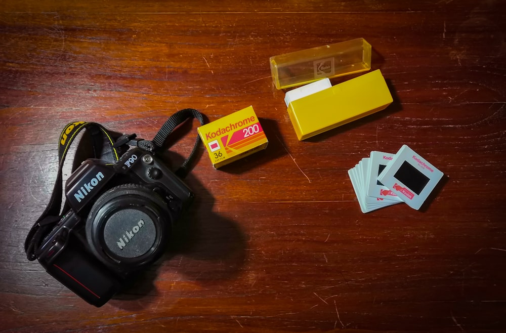 black nikon dslr camera on brown wooden table