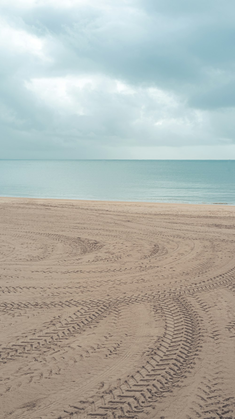 brown sand near body of water during daytime