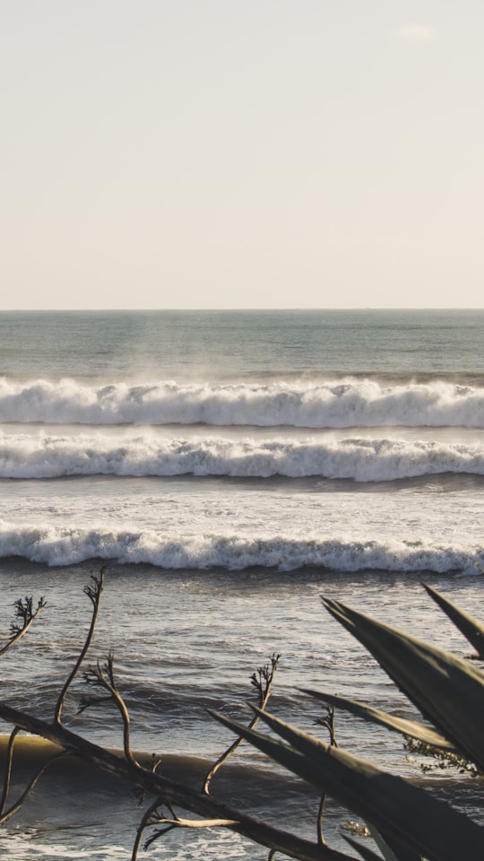 ocean waves crashing on shore during daytime in Estoril Portugal