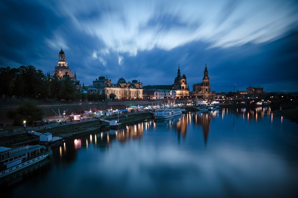 body of water near city buildings during night time