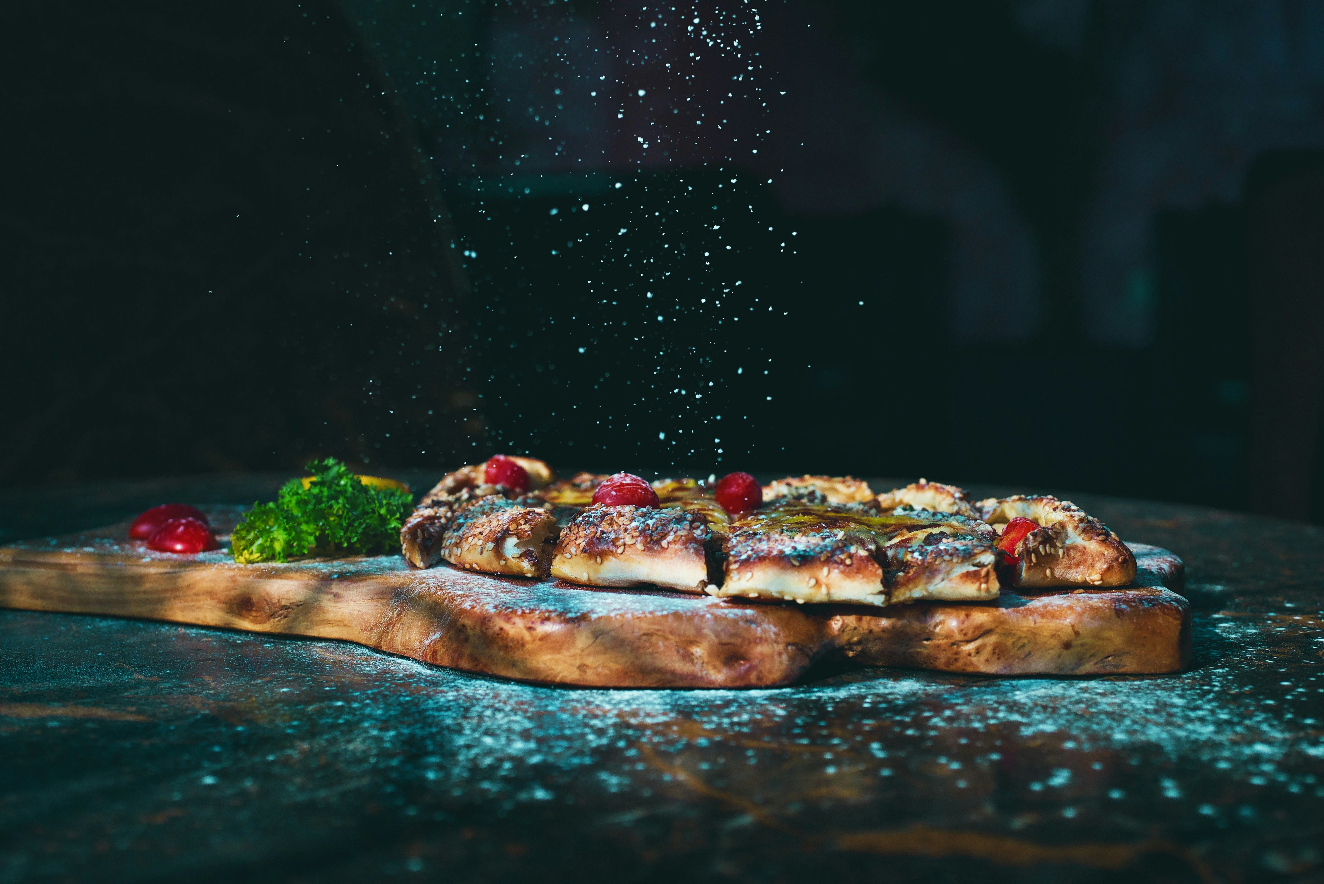 brown and red pizza on brown wooden table