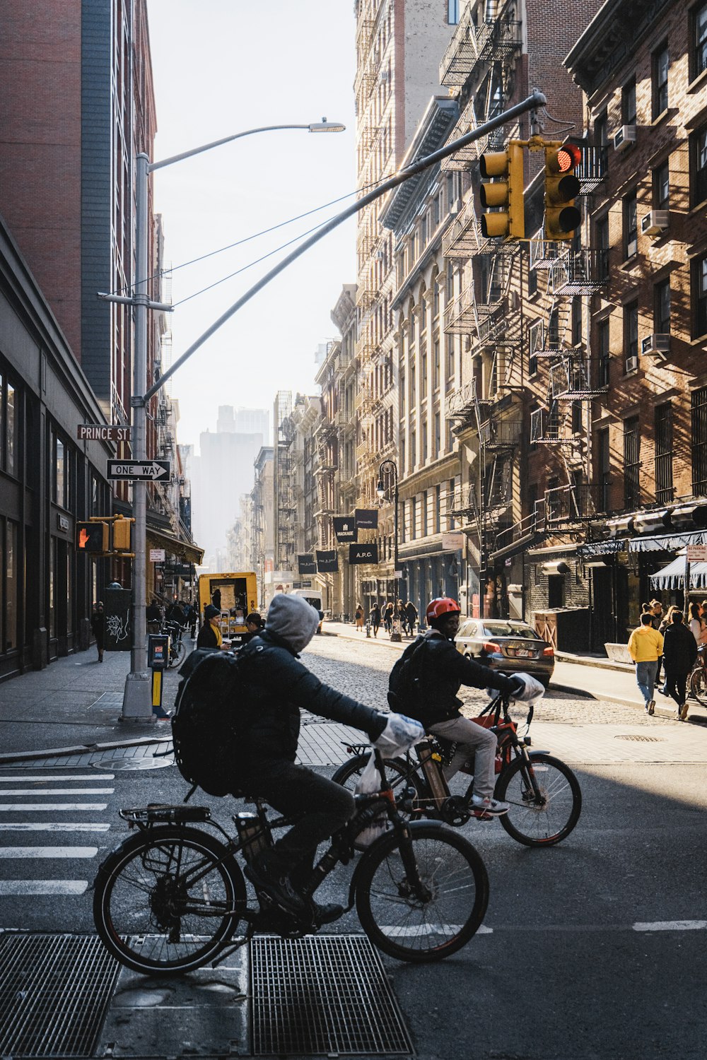 a couple of people riding bikes down a street