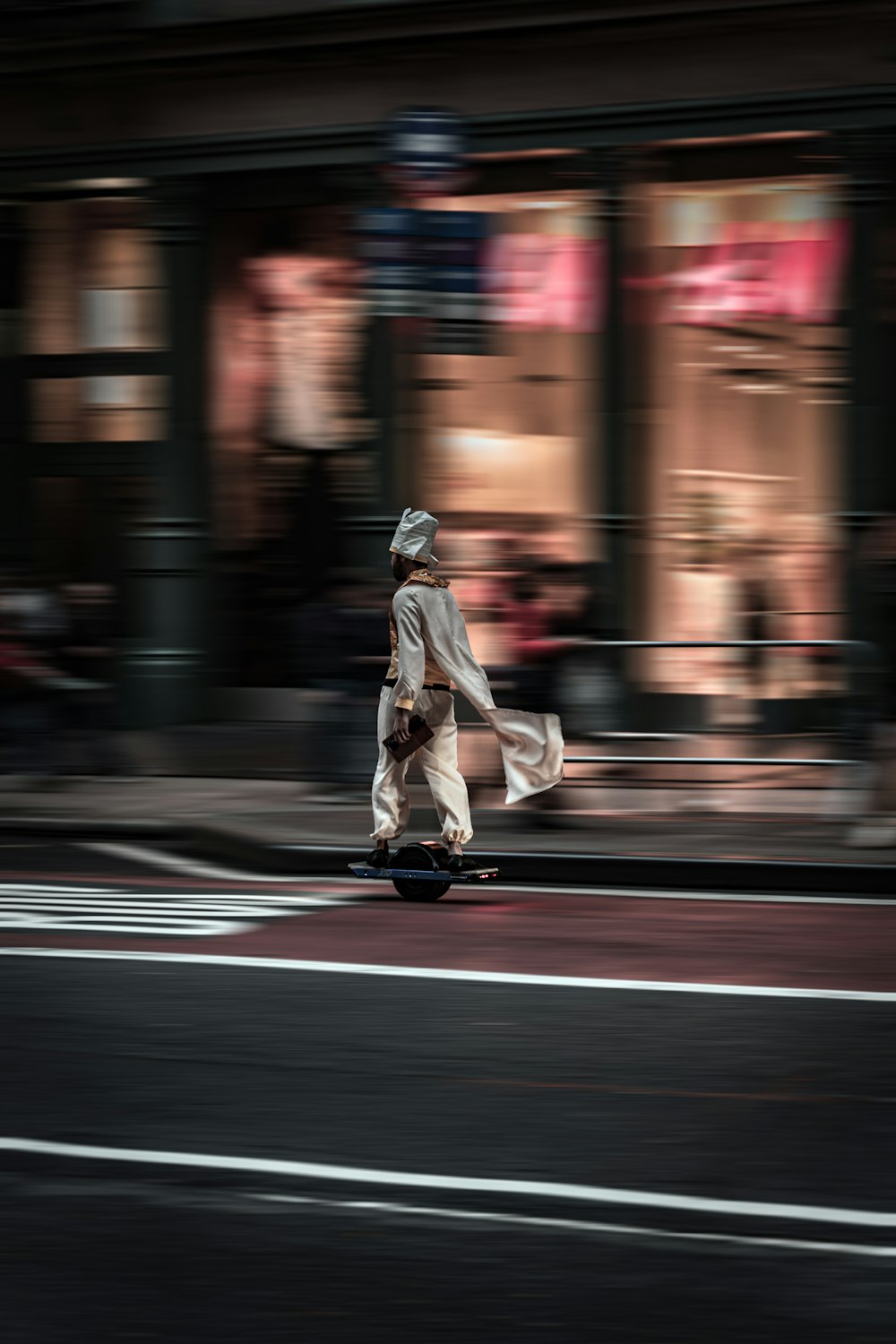 a man riding a skateboard down a street