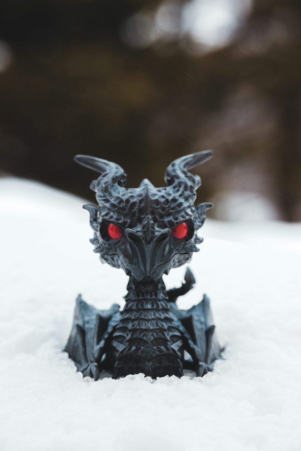 black dragon figurine on white textile