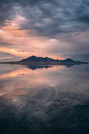 a large body of water under a cloudy sky