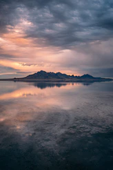 a large body of water under a cloudy sky