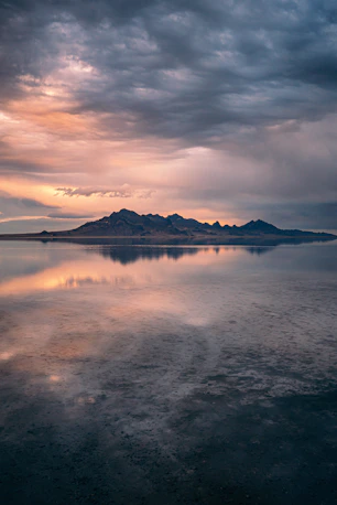 a large body of water under a cloudy sky