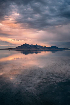 a large body of water under a cloudy sky